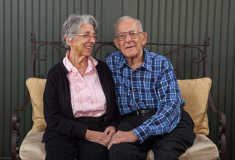 Couple sitting on a bench.